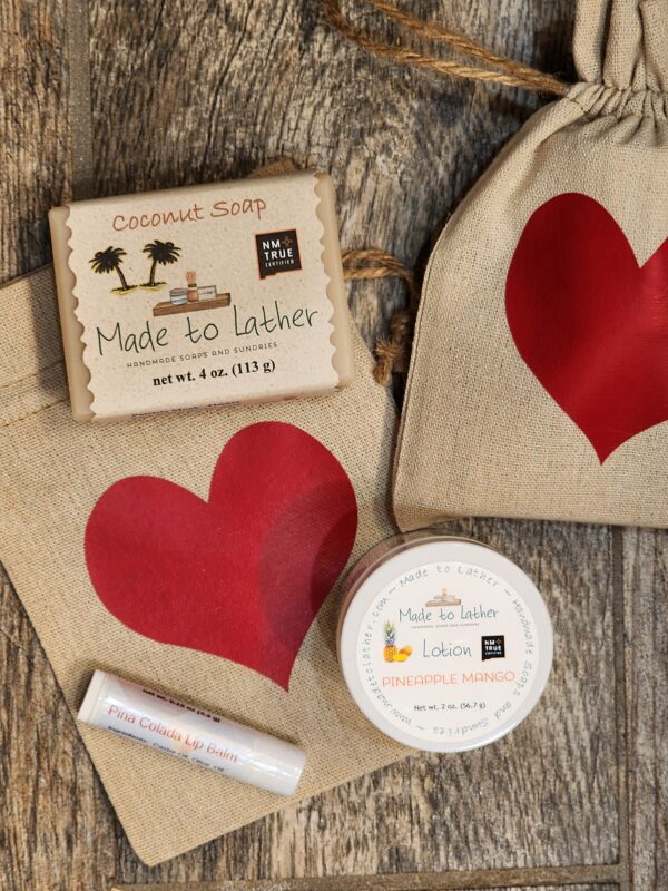 soap, lotion and lip balm in a muslin bag with red heart.