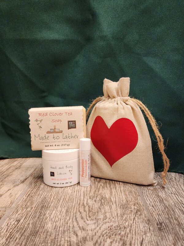 soap, lotion and lip balm in a muslin bag with red heart.