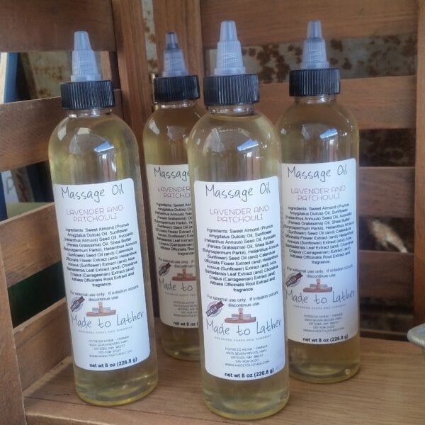 Four bottles of massage oil by made to lather
