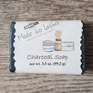 a bar of made to lather's charcoal soap